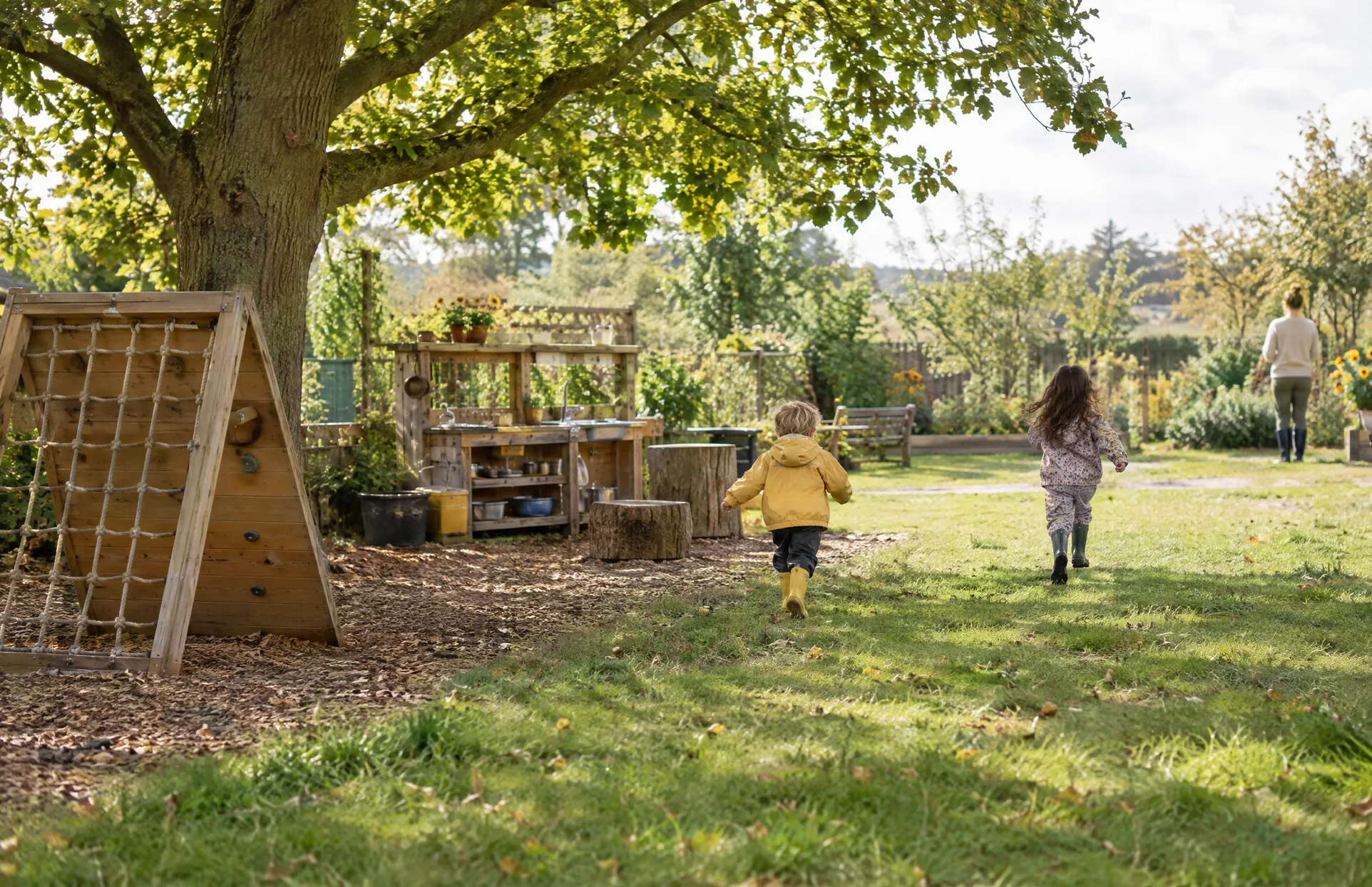 The nursery garden, with a climbing frame under the oak tree